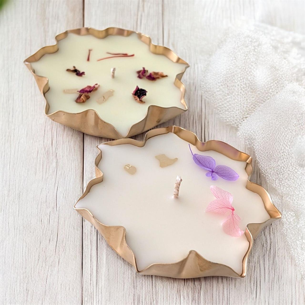 Gold-rimmed Studio Veeha candles with pressed petals